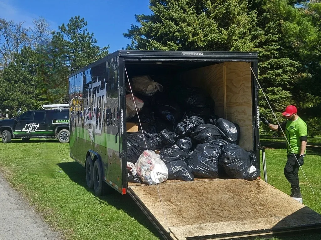 Junk removal crew loading and hauling debris